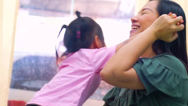 Happy loving family. Mother and her daughter child girl playing high five and hugging