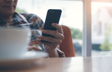 Man using smart phone in cafe
