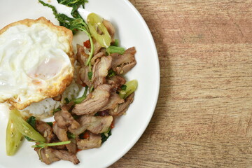 spicy stir fried slice grilled pork with chili and basil leaf topping egg on dish