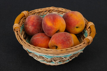 Peach heap in the wooden basket