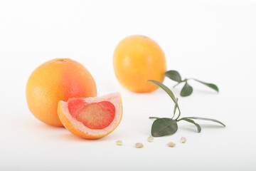 Fresh grapefruits with leaves isolated on white background.Two ripe, juicy grapefruits, one cut.