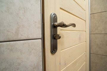 chrome door handle in the room, close up