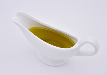 Sauce boat with olive oil on a white background. Isolated.