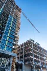 Fototapeta na wymiar High-rise buildings under construction on blue sky background.