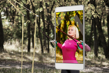 Pretty smiling sportswoman in autumn forest, saturated image in smartphones camera