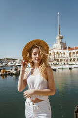 Fototapeta premium curly blonde against the background of the seaport