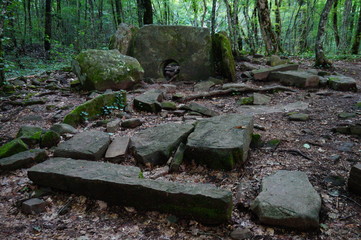 Stone structure in the forest. Dolmen.