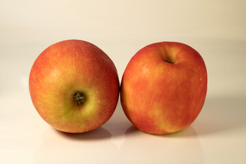 Two red apples on white background