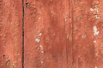 Old and peeling paint Over time, the red paint peeled off from the old boards and the wood texture cracked. Vintage Abstract Grunge Background