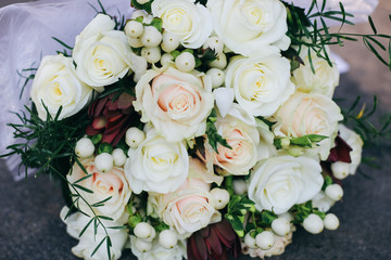 Wedding bouquet of white roses, white berries and protea