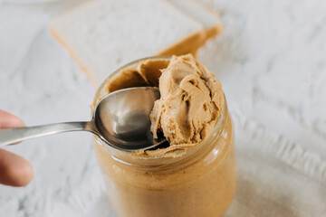 thick peanut butter in a jar close-up. Healthy eating.