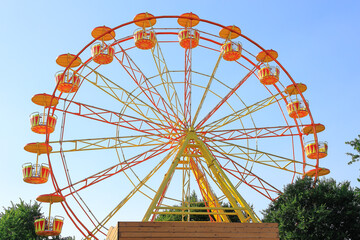 Ferris wheel against the summer blue sky