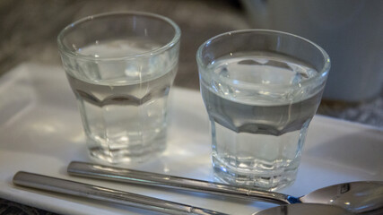 Two shot glasses filled with water in a coffee shop