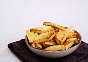 Homemade cottage cheese biscuits in a clay bowl on a light background concrete. Baking with cottage cheese.