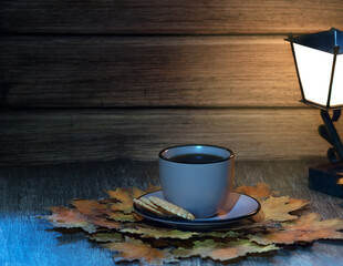 cup of fragrant tea on a wooden table against a background of autumn leaves, a great reason to warm up.