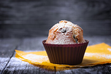 Handmade muffin close up on a black  wooden table