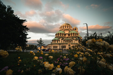 Obraz premium Famous Cathedral Saint Aleksandar Nevski during sunrise with illuminated colourful clouds during summer morning (Sofia, Bulgaria, Europe)