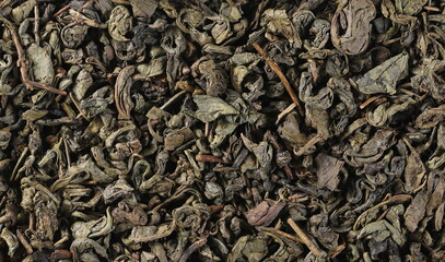 Dry green tea leaves background and texture
