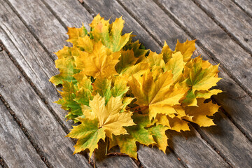 Naklejka na ściany i meble Heart is made of autumn maple leaves.