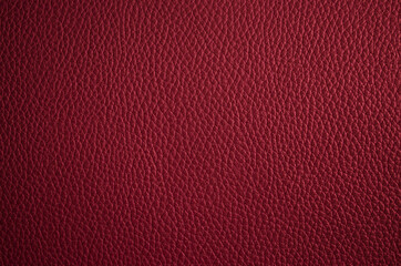 Leather texture. Dark red fashionable background. Stylish wallpaper of maroon color