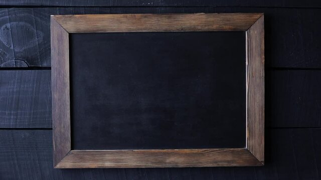 Old fashioned writing slate at wooden table
