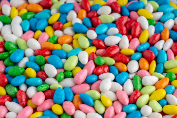 Fototapeta na wymiar Many candies in multi-colored glaze background