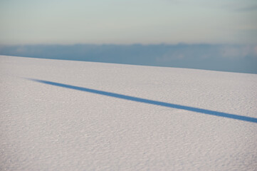 Snow and Shadow Surface at Sunset in the Mountains.