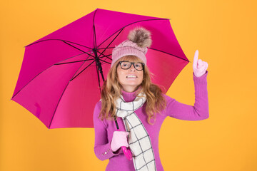 Obraz na płótnie Canvas adult woman sheltered with umbrella and colored background