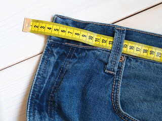 jeans and waist meter. Overweight and fashion