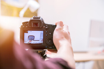 Filming with a digital camera: Man is using a camera standing on a tripod