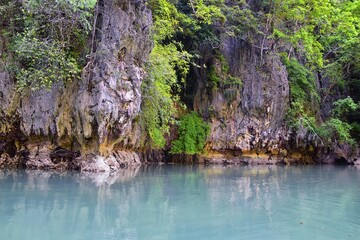 Island, Ocean views near Phuket Thailand with Blues, Turquoise and Greens oceans, mountains, boats, caves, trees resort island of phuket Thailand. Including Phi Phi, Ko Rang Yai, Ko Li Pe and other is