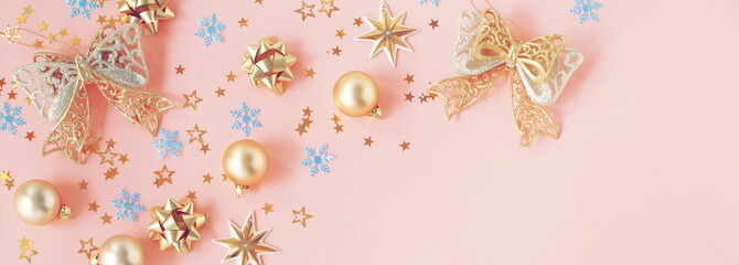 Christmas background banner. Xmas or new year gold blue decorations on pastel pink background with empty copy space for text.  holiday and celebration concept for postcard or invitation. top view 