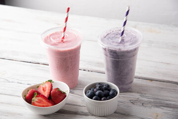 strawberry and blueberry smoothie in disposal plastic cup