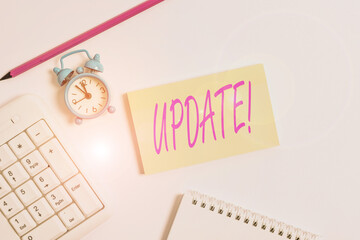 Text sign showing Update. Business photo text make something more modern or up to date like software programs White pc keyboard with empty note paper and pencil above white background