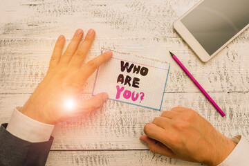 Conceptual hand writing showing Who Are You question. Concept meaning asking about demonstrating...