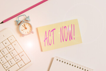 Text sign showing Act Now. Business photo text do not hesitate and start working or doing stuff right away White pc keyboard with empty note paper and pencil above white background