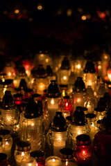 Group of burning grave candles during Polish All Saints' Day at cemetery. Polish traditions. Memorial day of those who passed away.