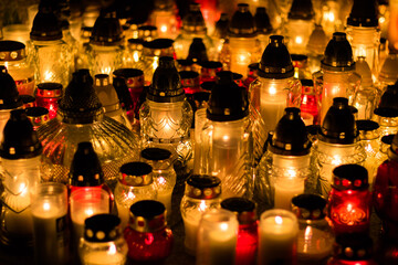 Group of burning grave candles during Polish All Saints' Day at cemetery. Polish traditions. Memorial day of those who passed away.