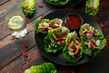 Vegetable lettuce wraps with carrot, onion, radish, red cabbage, cucumber and sweet chilli sauce