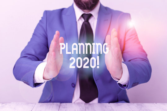 Word writing text Planning 2020. Business photo showcasing process of making plans for something next year Man holds empty paper with copy space in front of him Space