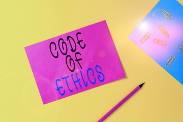 Writing note showing Code Of Ethics. Business concept for basic guide for professional conduct and...