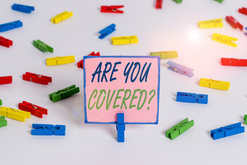 Text sign showing Are You Covered Question. Business photo text asking showing if they had insurance in work or life Colored clothespin papers empty reminder white floor background office