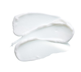 White texture and smear of face cream or white acrylic paint isolated on white background