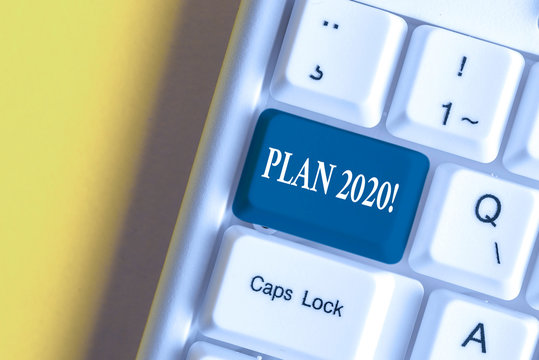 Handwriting text Plan 2020. Conceptual photo detailed proposal doing achieving something next year White pc keyboard with empty note paper above white background key copy space