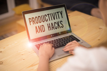 Writing note showing Productivity Hacks. Business concept for tricks that you get more done in the same amount of time woman with laptop smartphone and office supplies technology