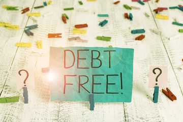 Handwriting text Debt Free. Conceptual photo does not owning any money to any individual or companies Scribbled and crumbling sheet with paper clips placed on the wooden table