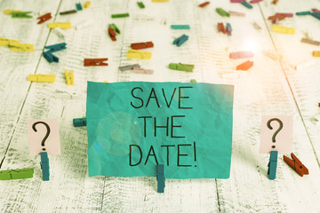 Handwriting text Save The Date. Conceptual photo Organizing events well make day special event organizers Scribbled and crumbling sheet with paper clips placed on the wooden table