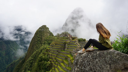 Woman Sitting On A Rock At Machu Picchu