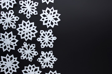 Naklejka na ściany i meble Festive Christmas background with white paper snowflakes