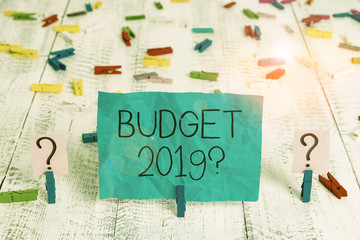 Handwriting text Budget 2019 Question. Conceptual photo estimate of income and expenditure for next year Scribbled and crumbling sheet with paper clips placed on the wooden table